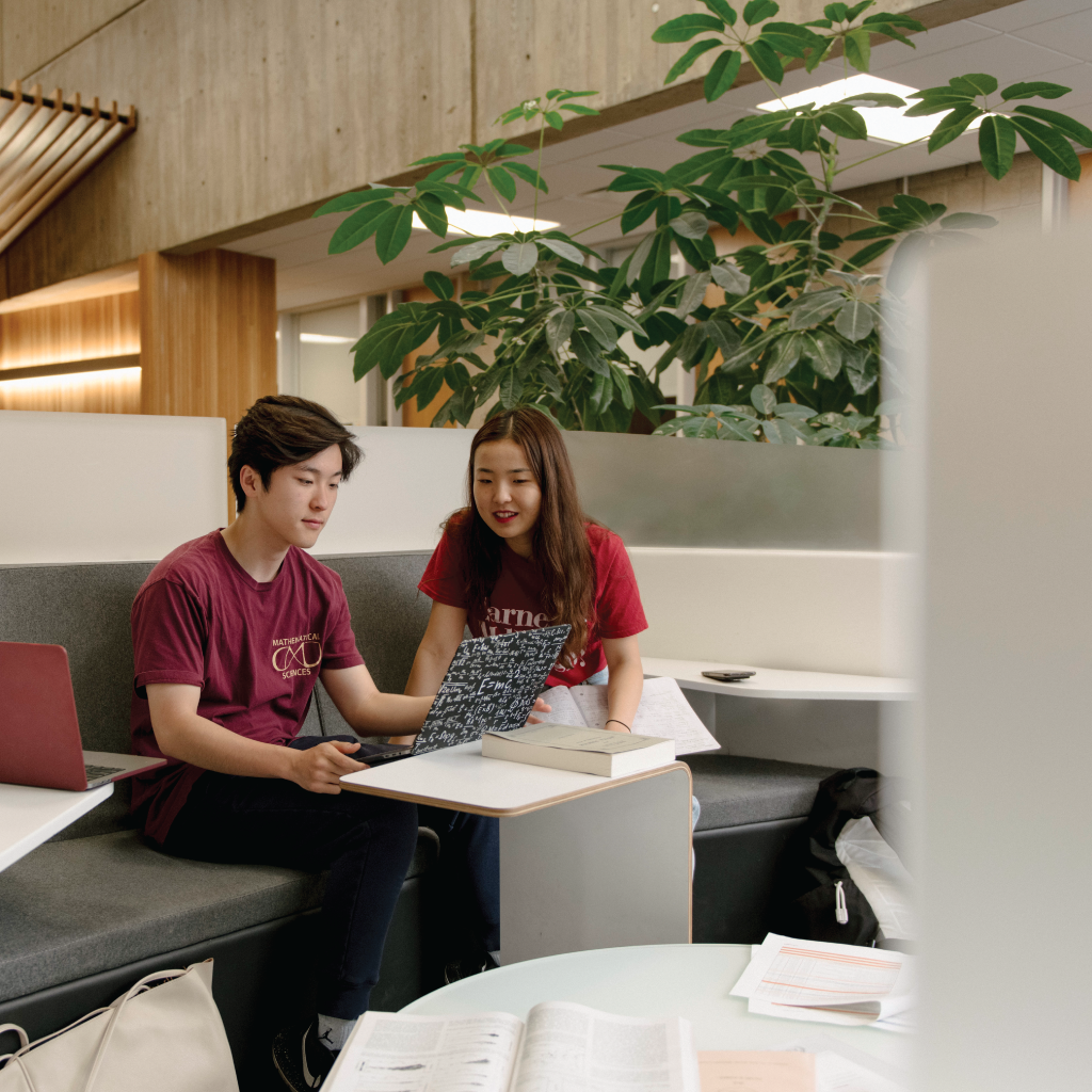 Students collaborate over a laptop