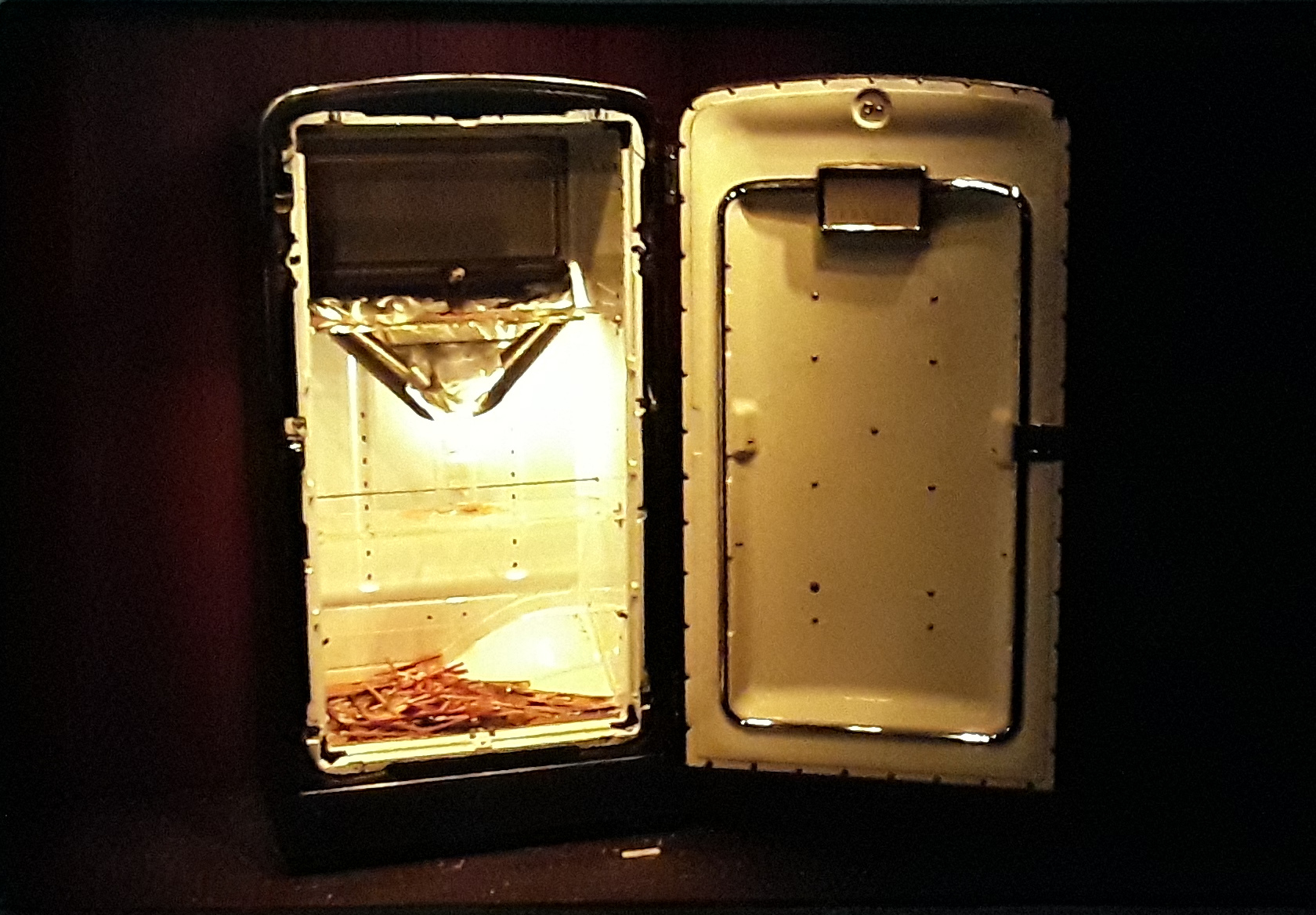 Silhouette image of refrigerator with pencil sharpener inside.