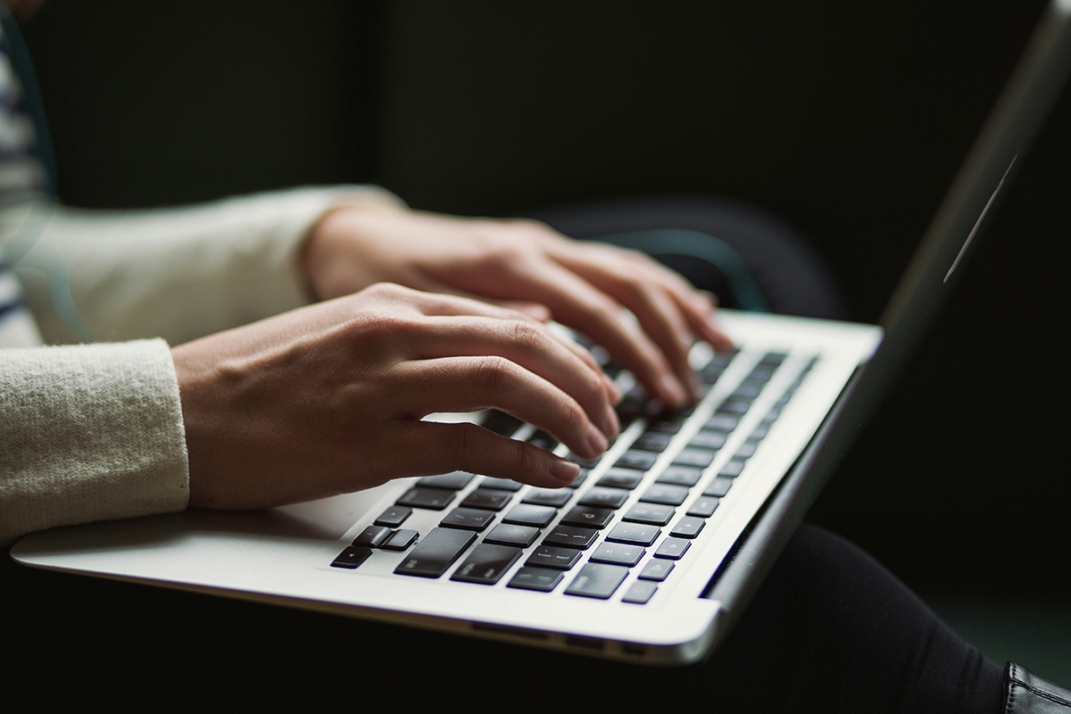 person typing on laptop