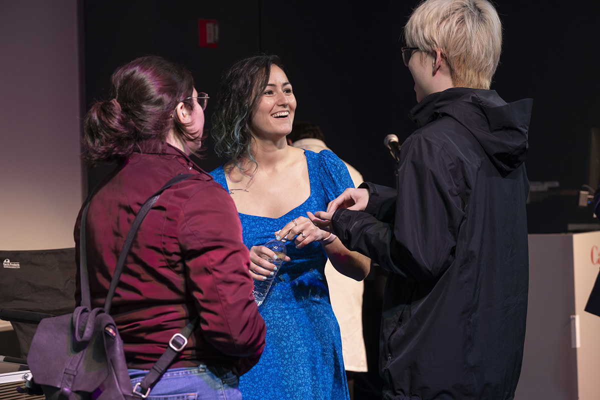 Uğur connects with current students after the event.