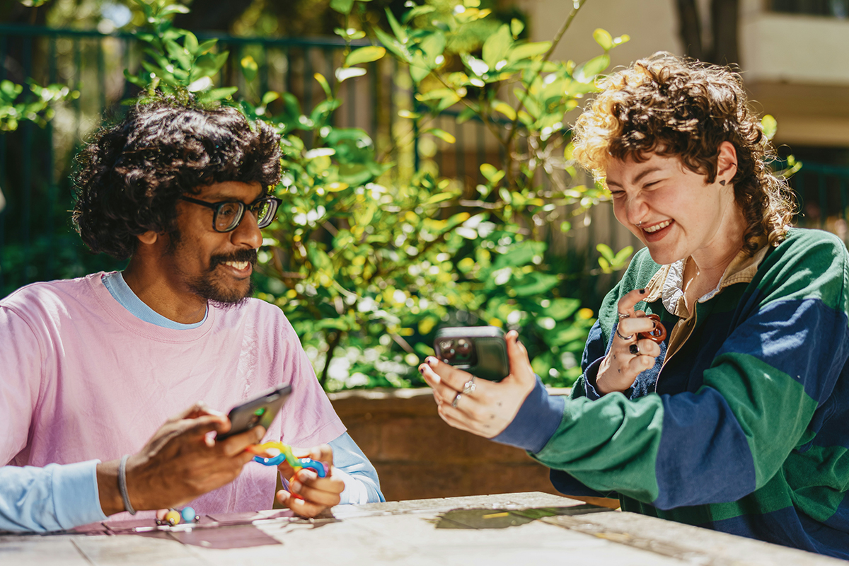 Image of two people sharing things on their phones