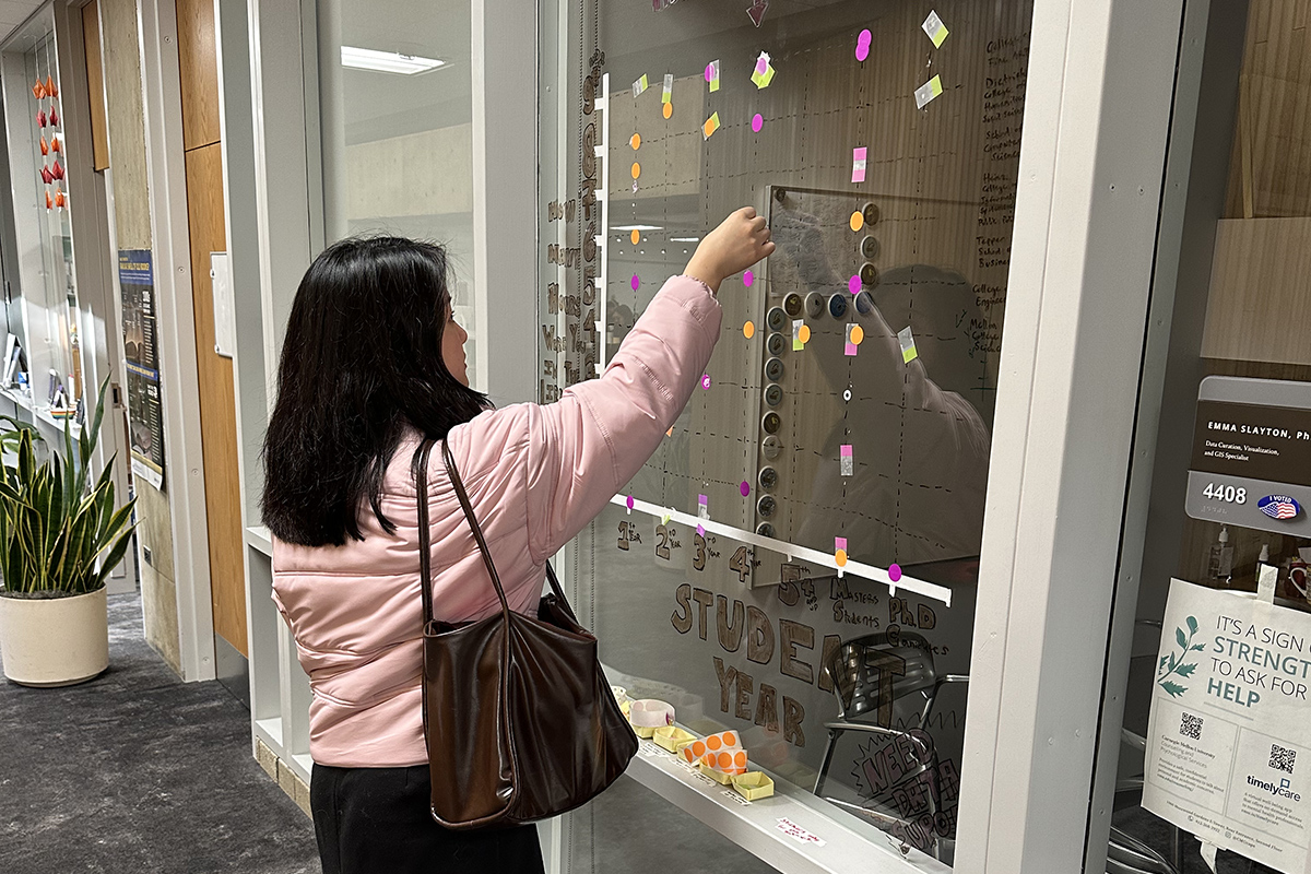 A student using the Data Visualization wall.