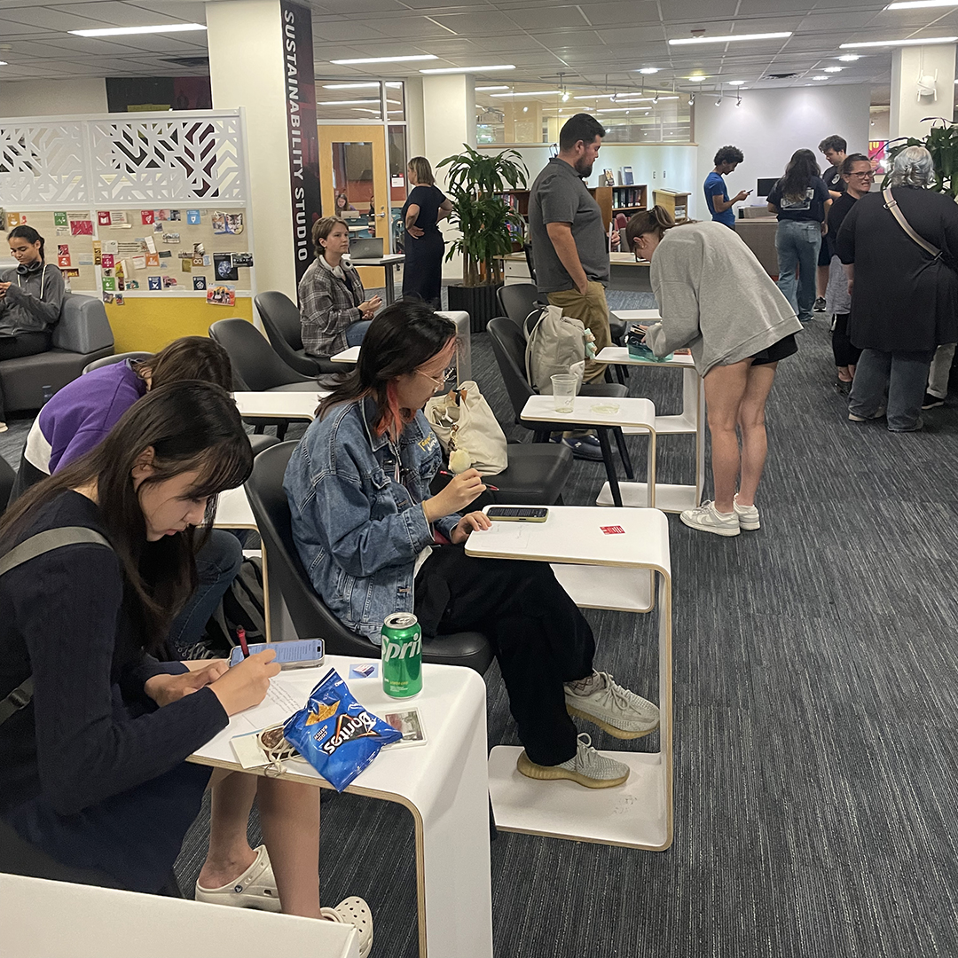 Students enjoy refreshments and get creative with their DIY voting postcards.