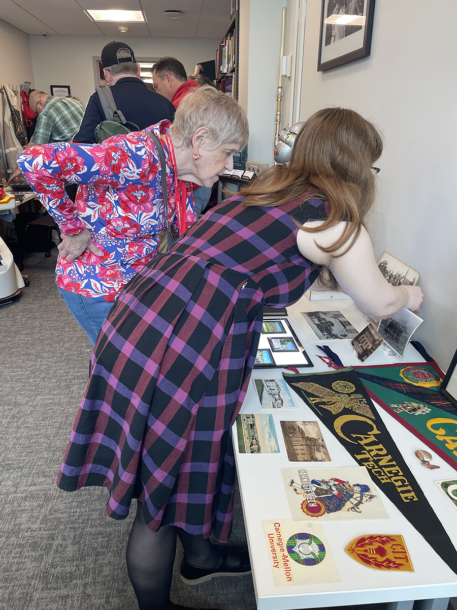 Lonna Smith, a 1969 graduate of the College of Fine Arts and longtime CMU volunteer and donor, examines images from the General Photograph Collection with Community Collections Processing Archivist Crystal Johnson.