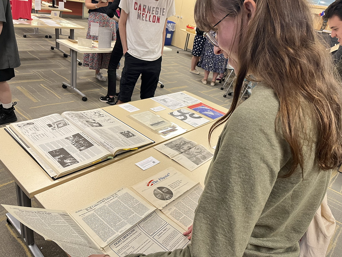 An attendee flips through a copy of The Phoenix, a conservative newspaper jointly published by students at CMU and the University of Pittsburgh from 1994–1998.