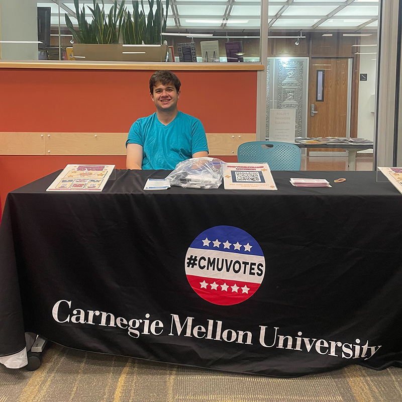 Dietrich College of Humanities and Social Sciences junior Zach Berger, who is a Voter Engagement Intern majoring in Social & Decision Sciences, staffs a table  to help attendees register to vote.