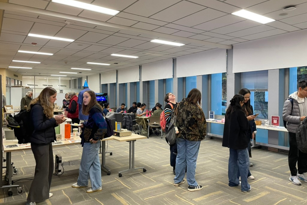 Students and alumni interacted with archival materials and past IDeATe projects while waiting for a slice of cake.