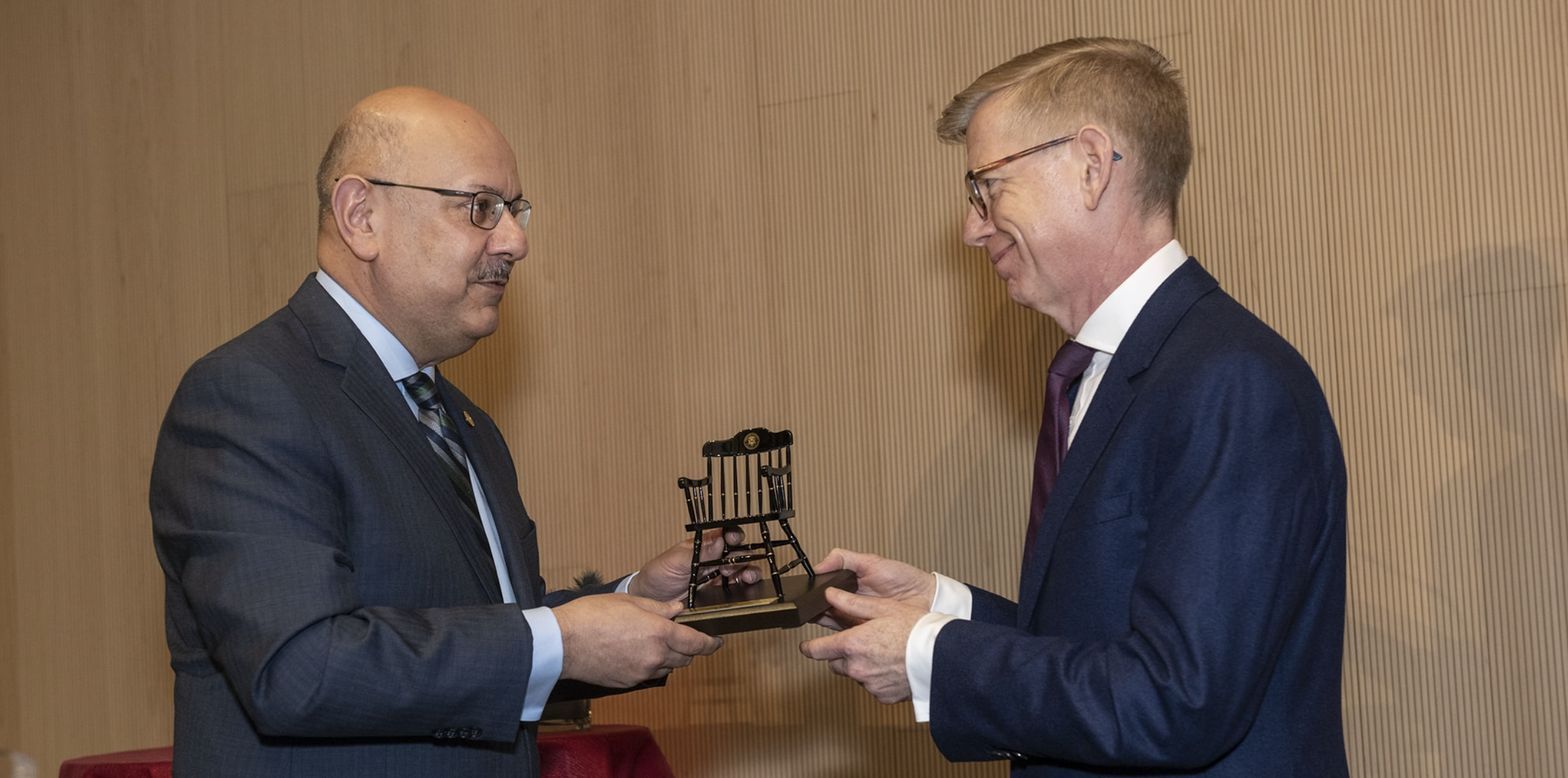 Carnegie Mellon President Farnam Jahanian presents Keith Webster, the inaugural Helen and Henry Posner, Jr. Dean's Chair for the University Libraries, with a model chair. 