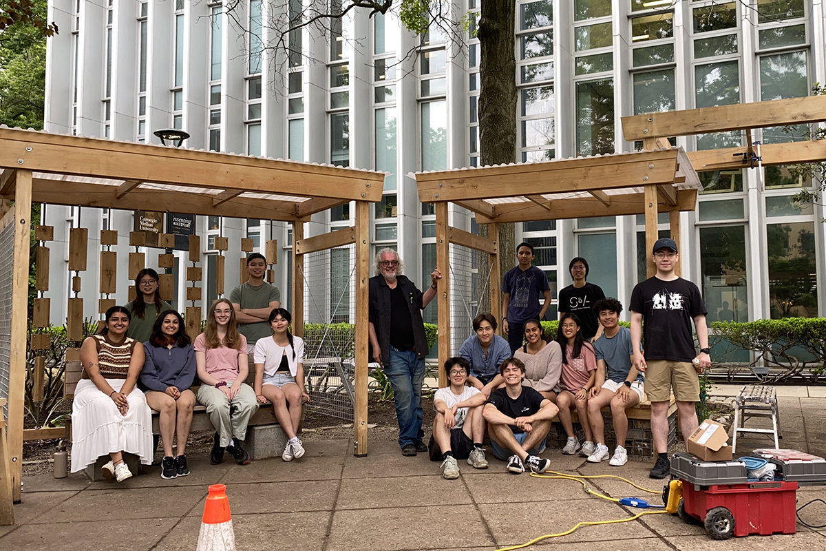 Professor Stephen Lee with students in front of their Peace Garden Project.